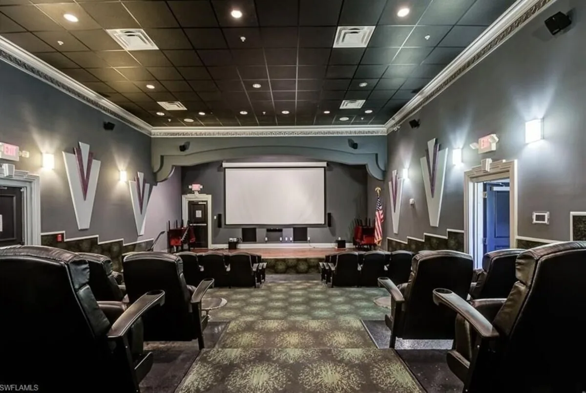 Paseo community movie theater with rows of reclining seats facing a large screen