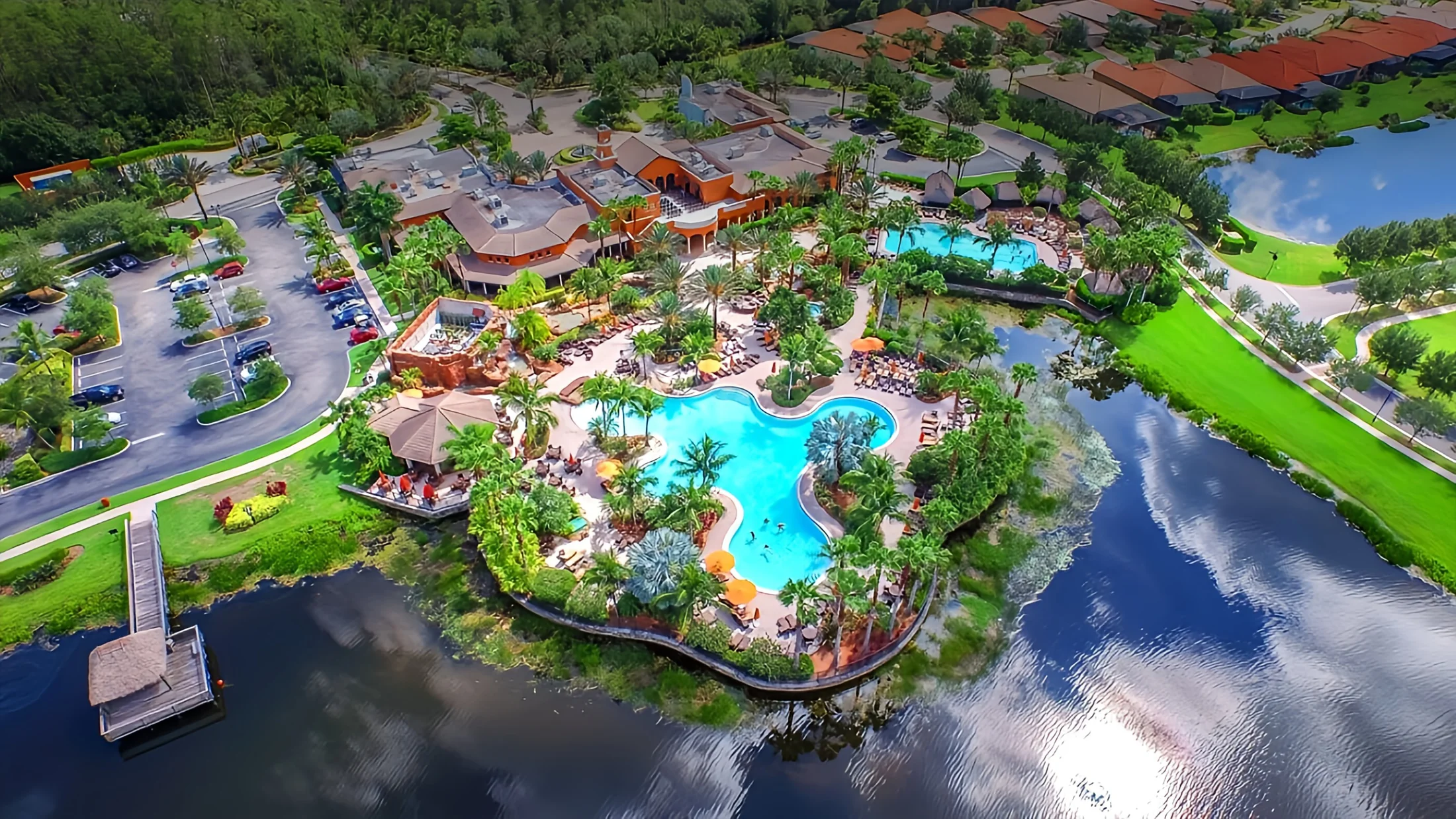 Aerial view of Paseo's shared resort pools, surrounded by palms